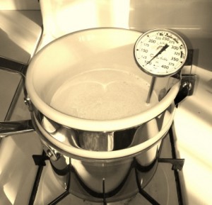 Double boiler with milk and thermometer